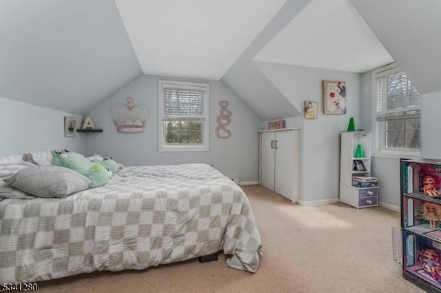 bedroom featuring lofted ceiling, baseboards, and light colored carpet