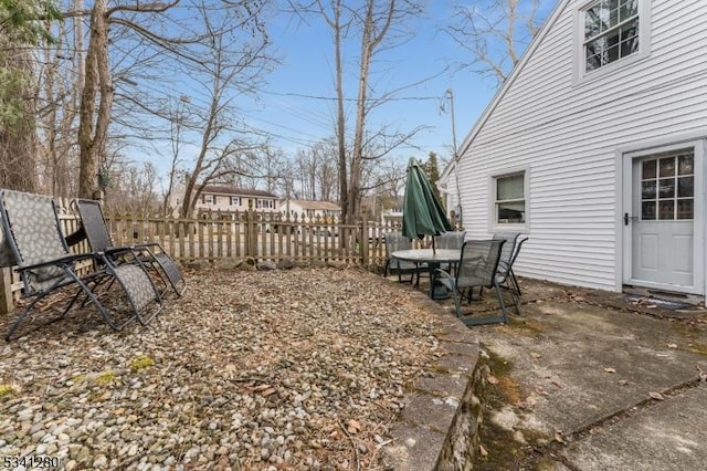 view of yard featuring fence and a patio