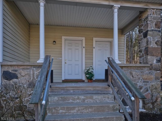 entrance to property with stone siding and covered porch