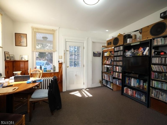 carpeted home office featuring radiator heating unit