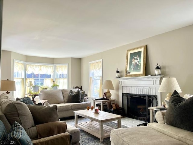 living room featuring a brick fireplace