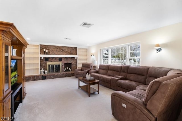 living area featuring visible vents, built in shelves, light colored carpet, and a fireplace