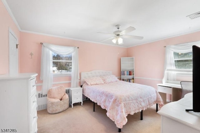 bedroom with visible vents, light colored carpet, crown molding, and ceiling fan