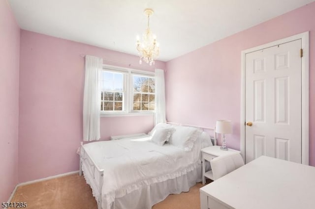 bedroom with baseboards, light carpet, and a notable chandelier