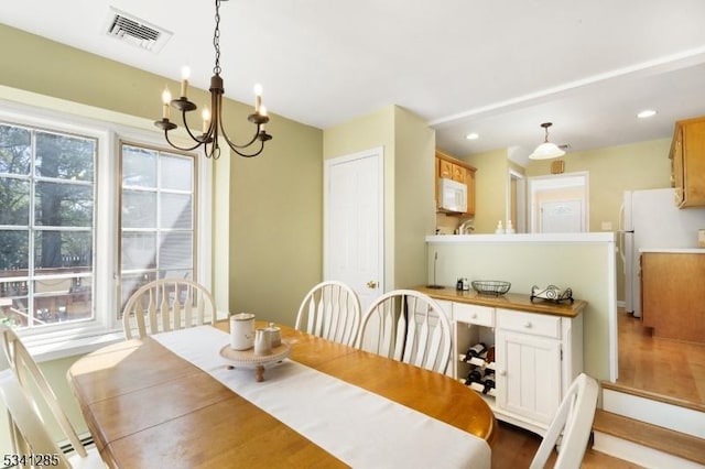 dining area featuring visible vents, recessed lighting, and an inviting chandelier