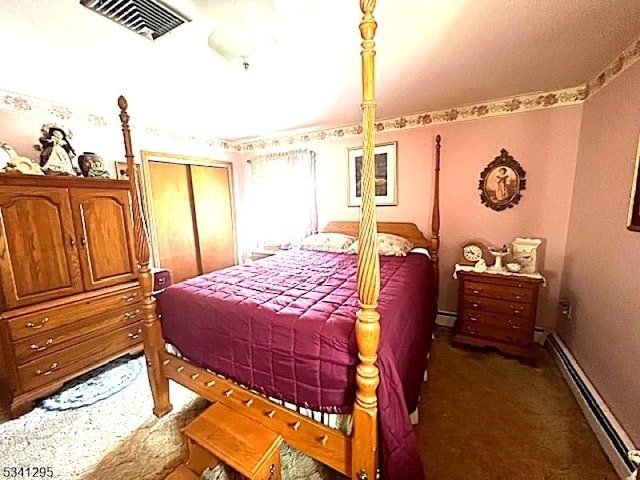 carpeted bedroom with a baseboard heating unit, visible vents, and baseboards