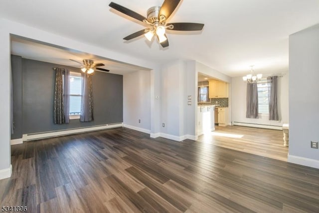 unfurnished living room featuring a baseboard radiator, a baseboard heating unit, wood finished floors, baseboards, and ceiling fan with notable chandelier