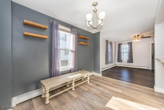 dining room with a baseboard heating unit, baseboards, baseboard heating, and wood finished floors