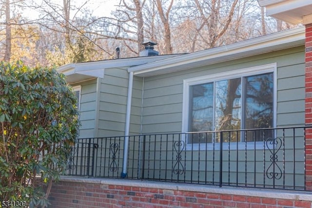 view of home's exterior featuring brick siding and a chimney