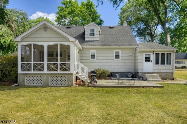 back of property with a shingled roof, a sunroom, a chimney, a yard, and a patio area