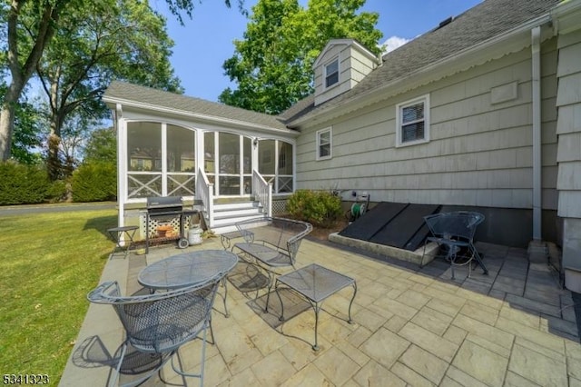 view of patio / terrace with area for grilling and a sunroom