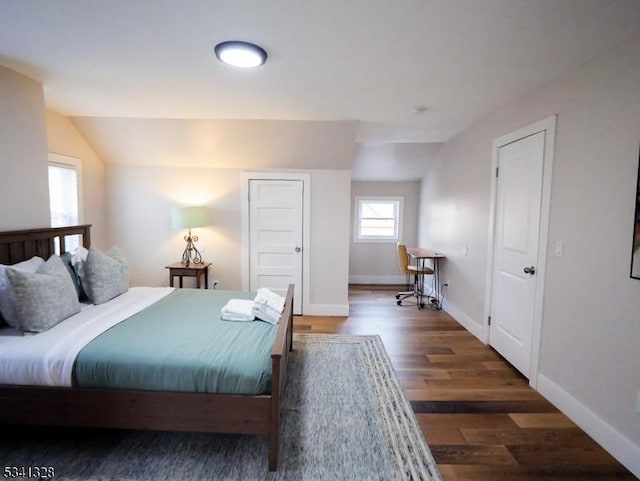 bedroom featuring vaulted ceiling, wood finished floors, and baseboards