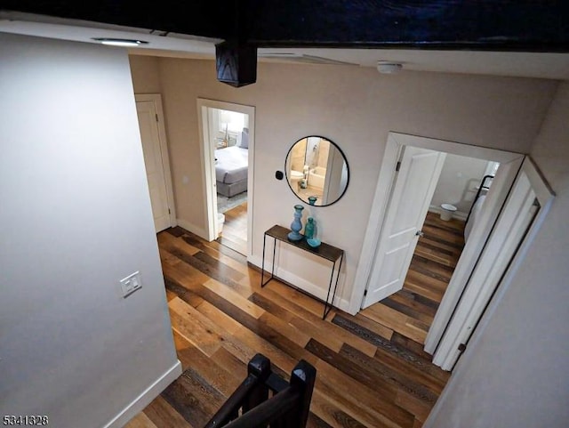 hall with wood finished floors and baseboards