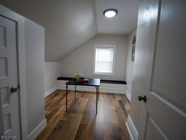 office space with lofted ceiling, hardwood / wood-style floors, and baseboards