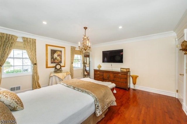 bedroom featuring ornamental molding, multiple windows, baseboards, and wood finished floors