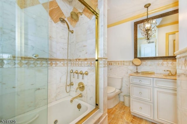 full bath featuring toilet, shower / bath combination with glass door, tile walls, vanity, and crown molding