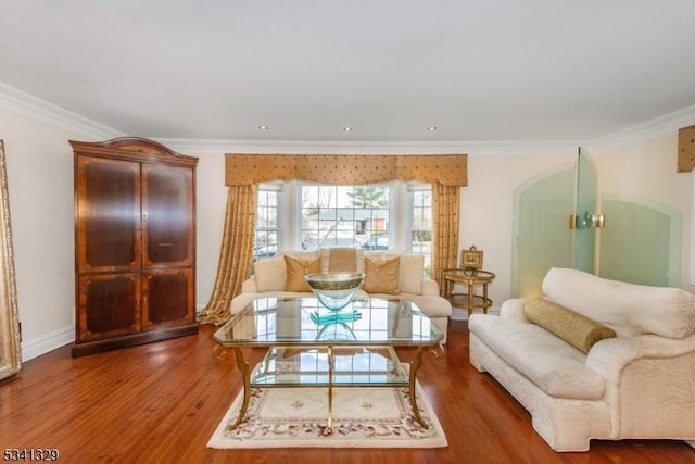 living room with baseboards, ornamental molding, and wood finished floors