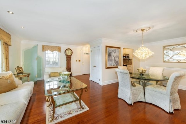 dining area featuring wood finished floors and crown molding