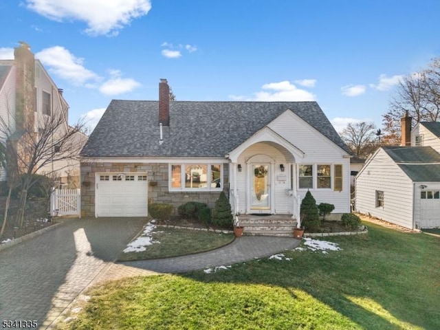 view of front of house featuring aphalt driveway, an attached garage, a gate, stone siding, and a front lawn