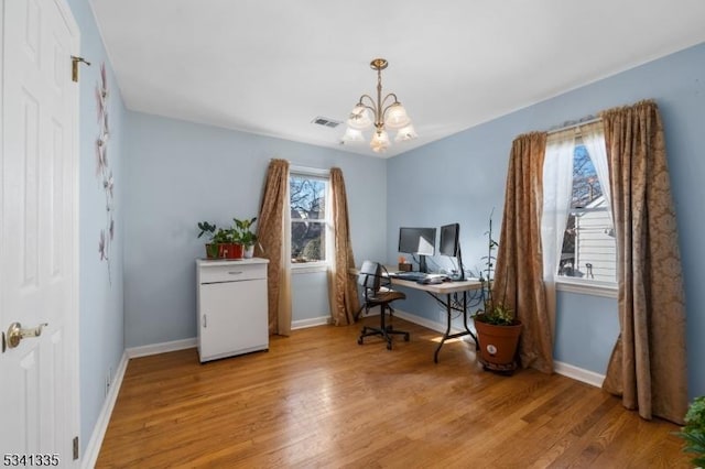 home office featuring baseboards, visible vents, an inviting chandelier, and wood finished floors