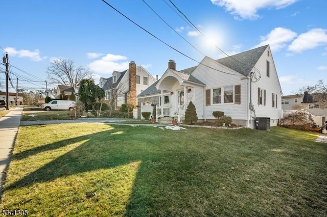 view of front of property featuring a front lawn and central AC unit