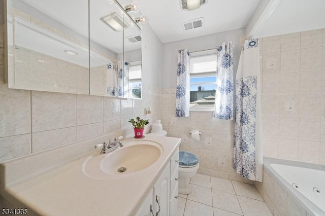 full bathroom featuring tile patterned flooring, toilet, vanity, visible vents, and tile walls