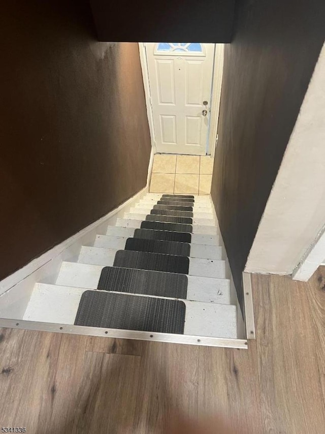 staircase with tile patterned flooring and baseboards