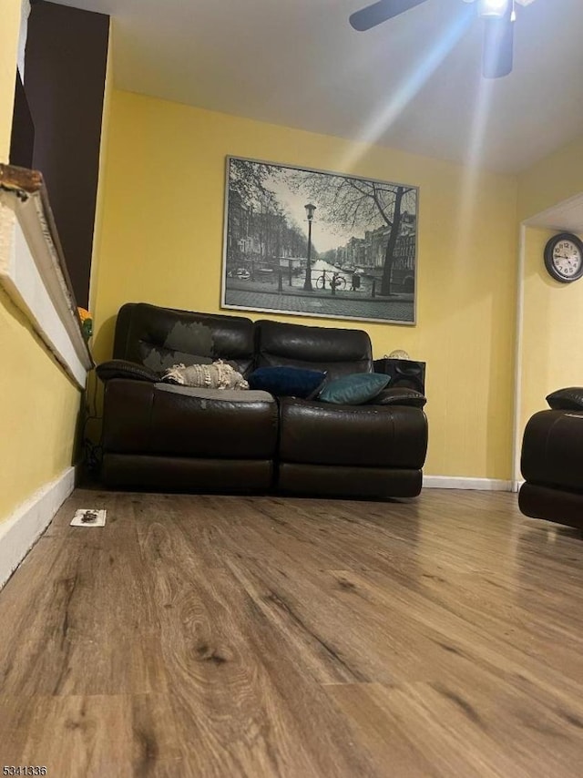 living area with ceiling fan, wood finished floors, and baseboards