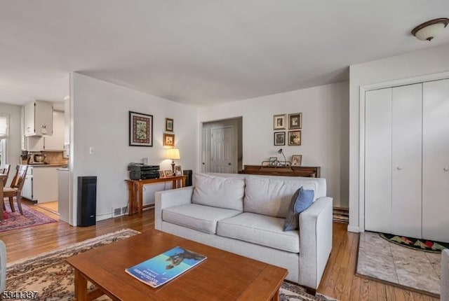 living room featuring light wood finished floors and visible vents