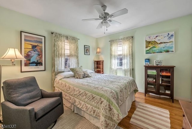 bedroom with wood finished floors and a ceiling fan