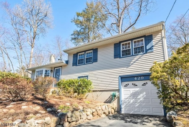 split level home with a garage and driveway