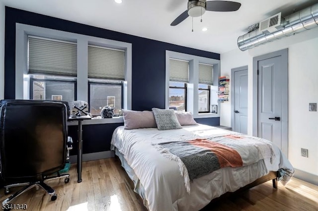 bedroom featuring ceiling fan, wood finished floors, and recessed lighting