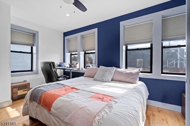 bedroom with a ceiling fan, recessed lighting, and wood finished floors