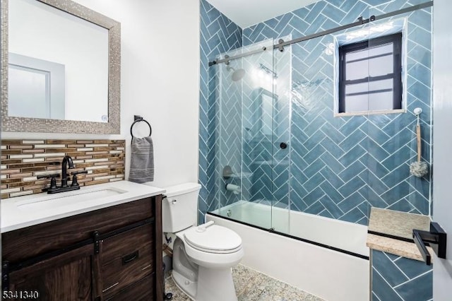 full bathroom featuring toilet, bath / shower combo with glass door, tasteful backsplash, and vanity