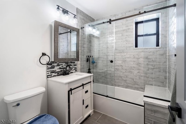 bathroom with toilet, enclosed tub / shower combo, tile patterned floors, vanity, and backsplash