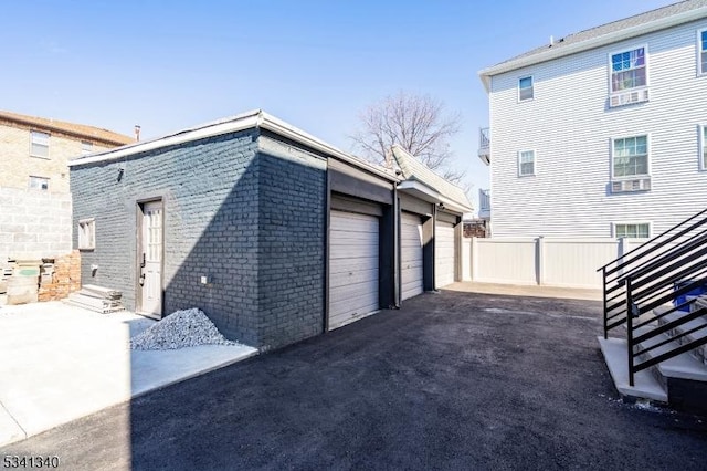 view of property exterior with brick siding and fence