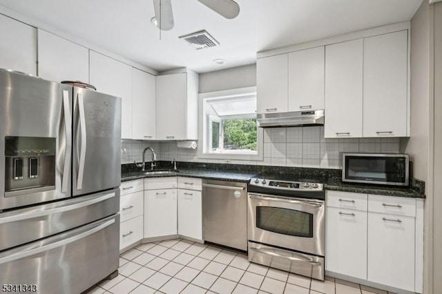 4 Dorrien Rd, Livingston Twp, NJ 07039 - kitchen featuring appliances with stainless steel finishes, under cabinet range hood, white cabinets, decorative backsplash, and ceiling fan