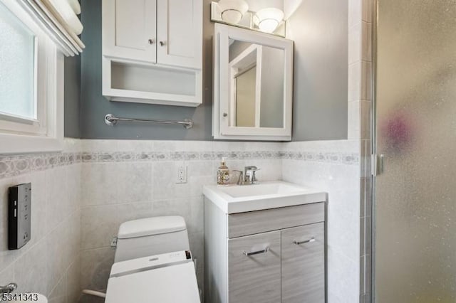 4 Dorrien Rd, Livingston Twp, NJ 07039 - bathroom with vanity, a stall shower, a wainscoted wall, and tile walls