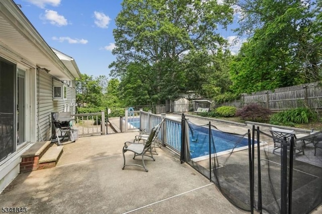 4 Dorrien Rd, Livingston Twp, NJ 07039 - view of pool featuring a fenced backyard, a patio, a shed, and view of scattered trees