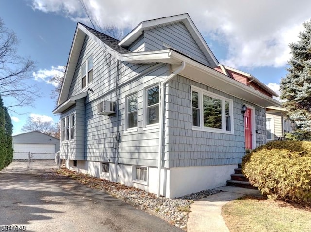 exterior space featuring a garage and an outbuilding