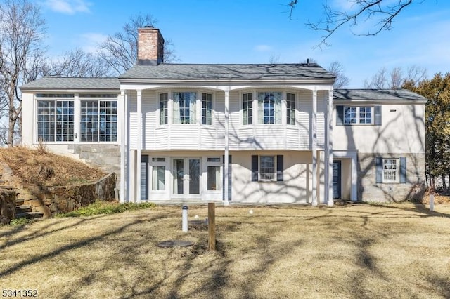 rear view of property with french doors and a chimney