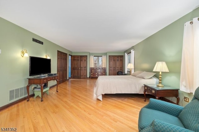 bedroom featuring visible vents and light wood-style flooring