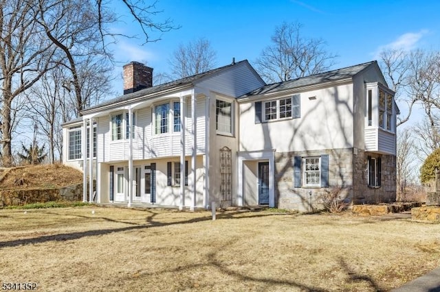 view of front of home featuring a front yard and a chimney