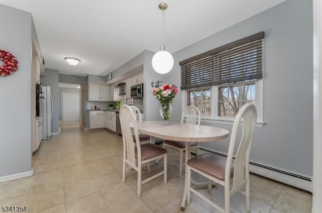 dining room with a baseboard radiator, baseboards, and light tile patterned floors