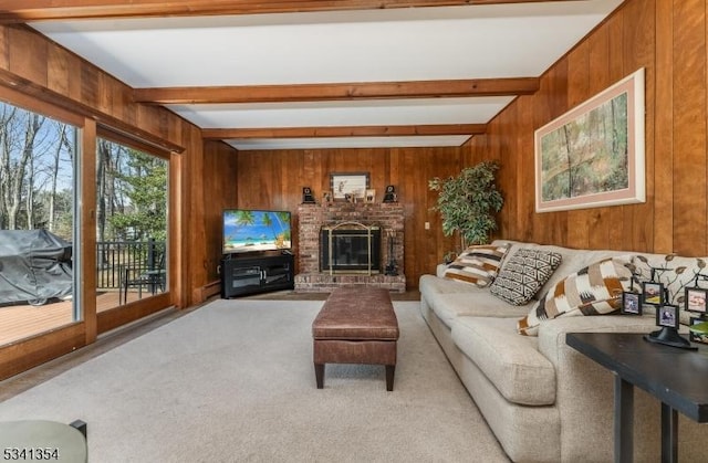 living room with carpet floors, beam ceiling, and wood walls