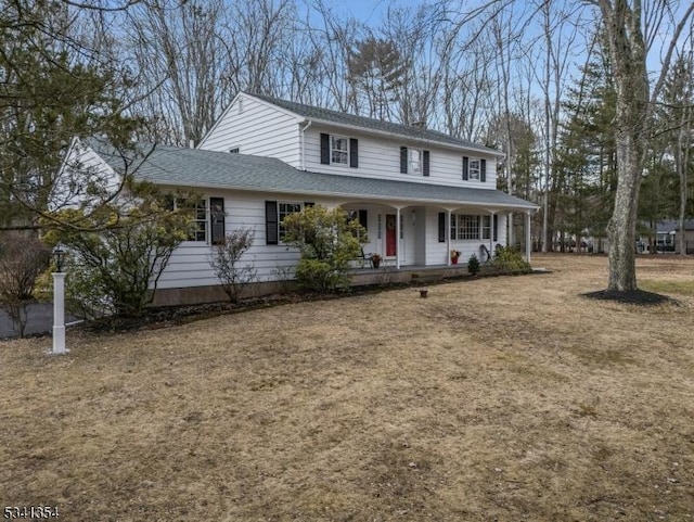 view of front of property featuring a porch and roof with shingles