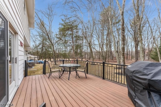 deck featuring a grill and outdoor dining space