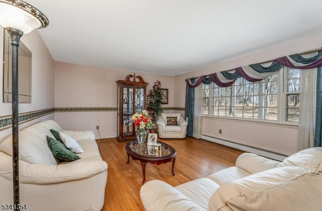 living room featuring baseboard heating and wood finished floors