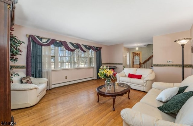 living room with baseboard heating and wood finished floors