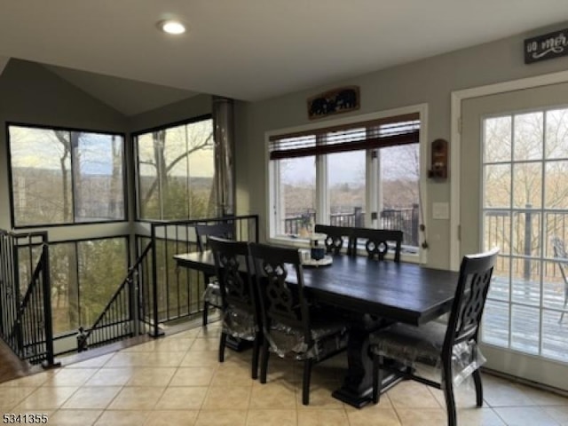 dining room with light tile patterned floors, vaulted ceiling, and recessed lighting